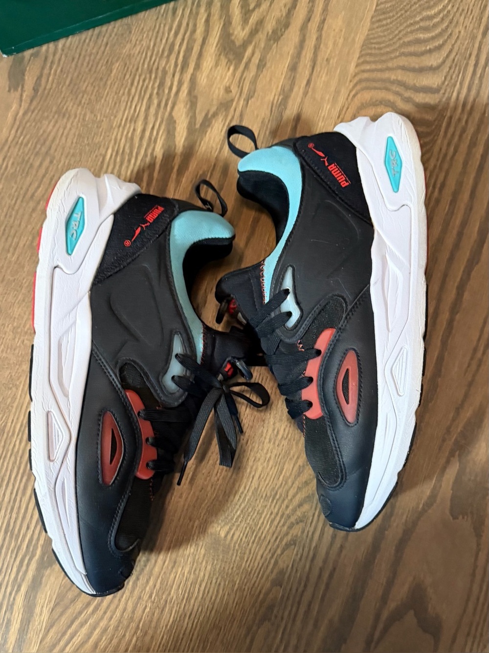 Puma Black Sneakers with Red Accents and Light Blue Collar